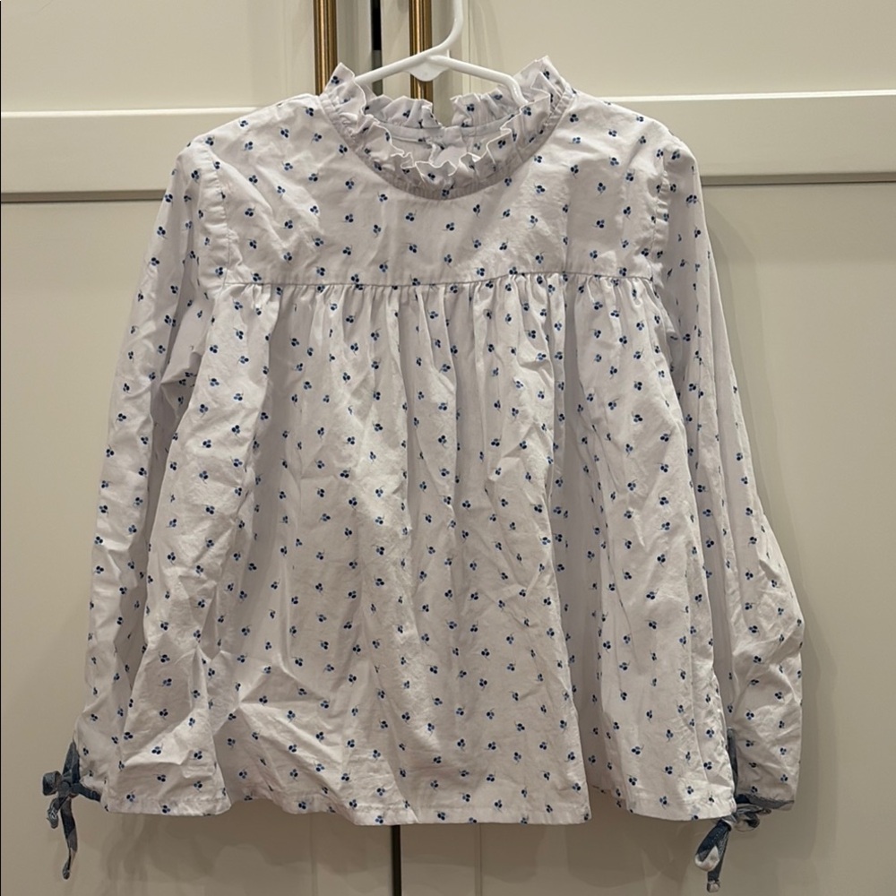 Ruffled White Blouse with Blue Floral Pattern